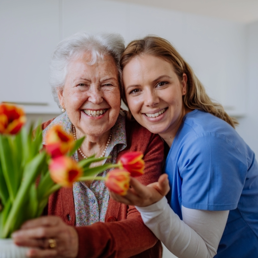 caregiver hugging the elderly