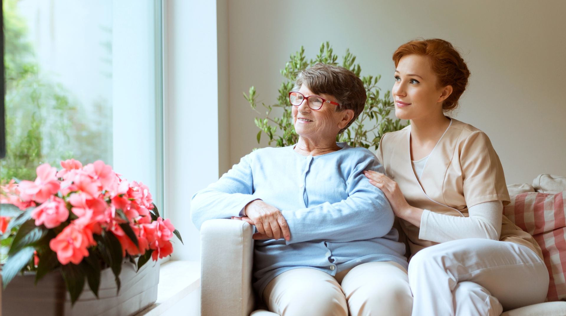 caregiver and elderly watching outside